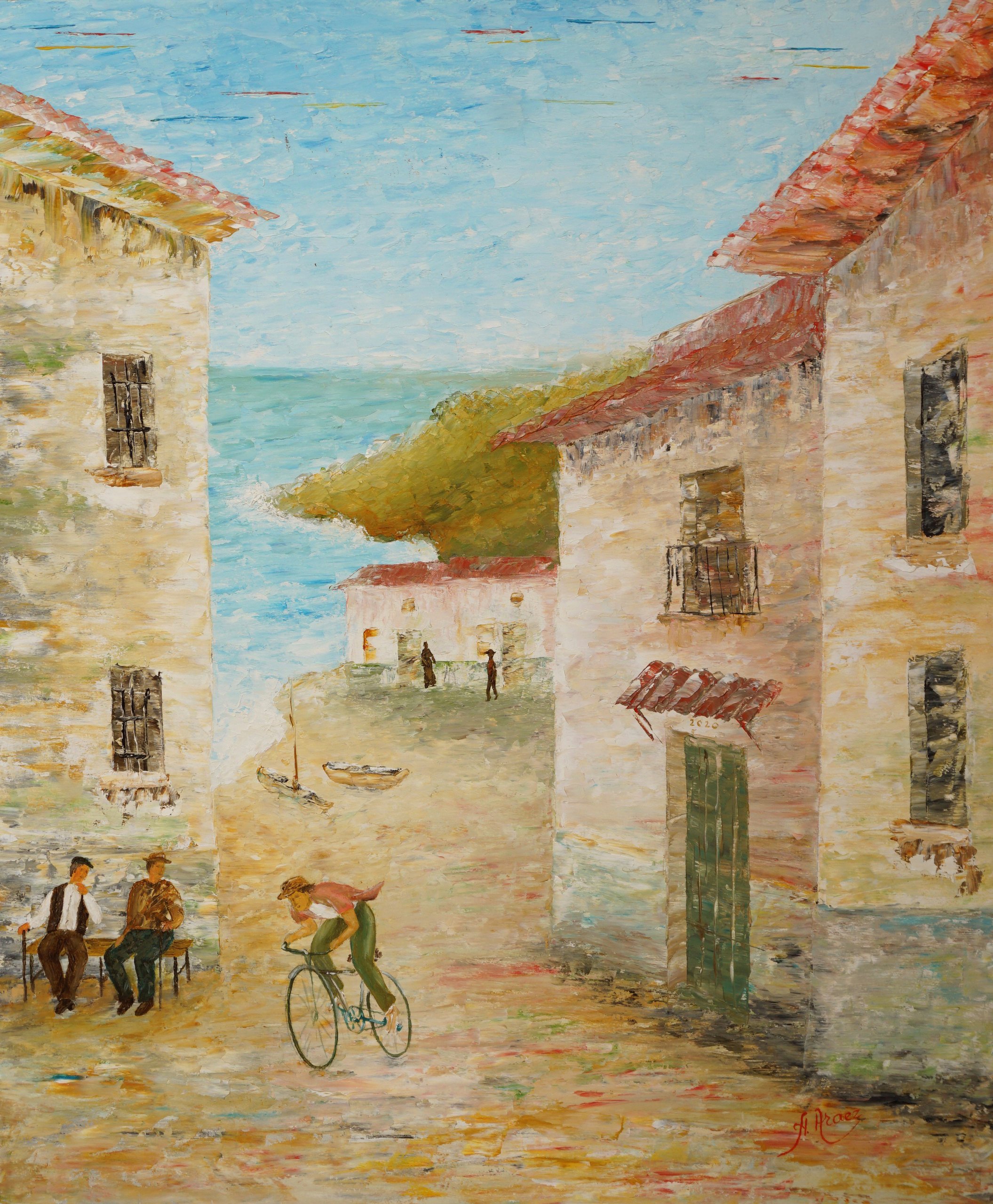La calle de casas blancas baja a buscar el mar; en un banco, dos hombres conversan al sol, pasa un ciclista, y al fondo las barcas esperan en la arena.